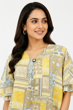 Close-up - jewel button yellow patchwork top