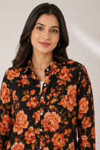Close-up - orange rose on black floral shirt