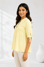 Side three-quarter pose - yellow peplum kurti