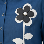 Texture shot - blue ribbed fabric with floral appliqué