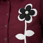 Texture shot - burgundy ribbed fabric with floral appliqué